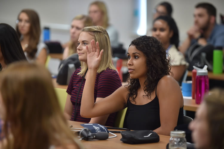 PA student raising her hand in class